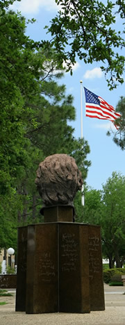 image of Mirabeau statue and US flag on a sunny day