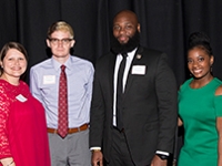 Alumni Board President Chris Bates and Ariana Jones pose with Alumni Director Shannon Figueroa and the Distinguished Alumni Scholarship Recipient Jean-Luc Baker.