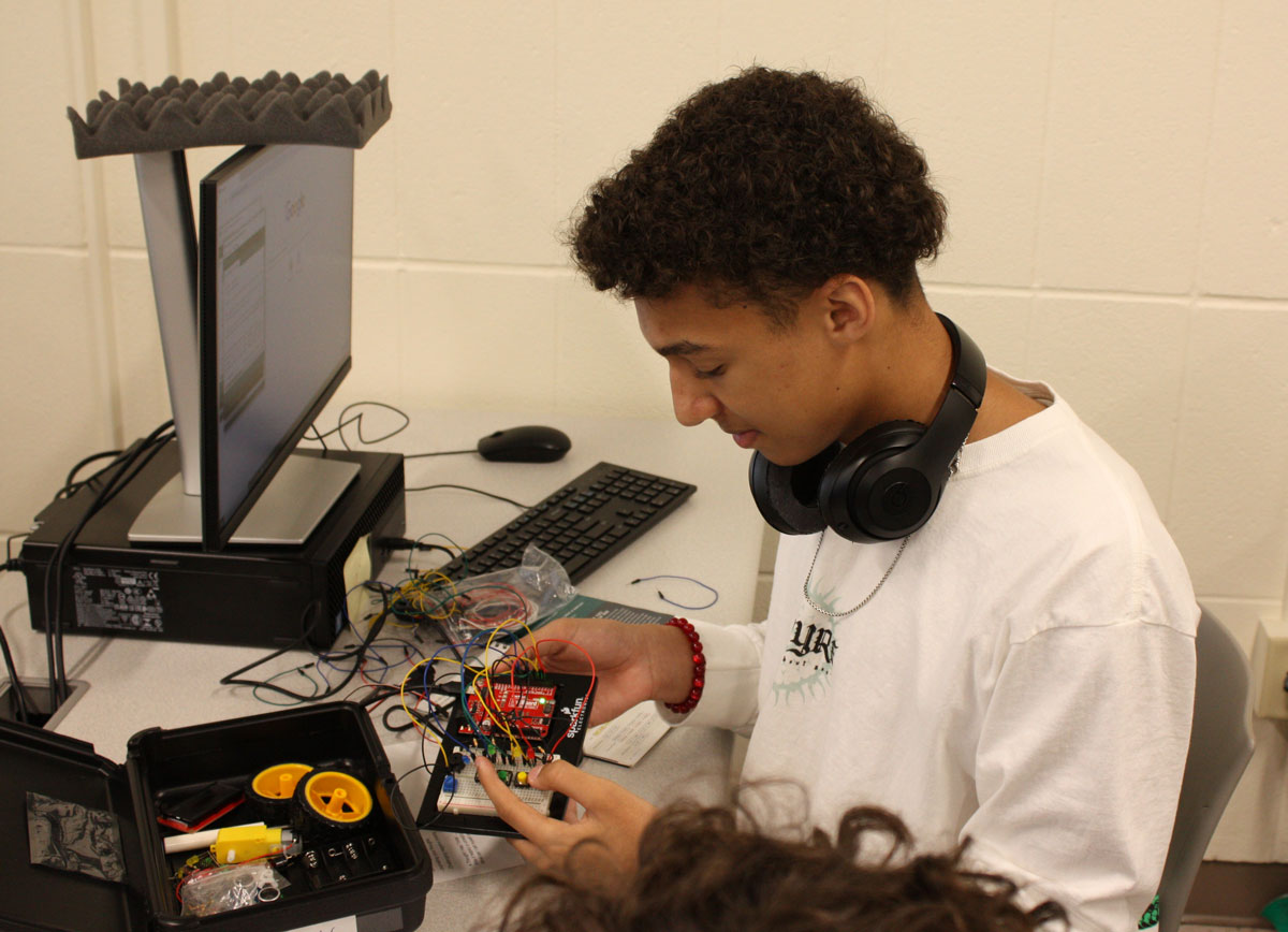 Student working on electronics at robotics camp