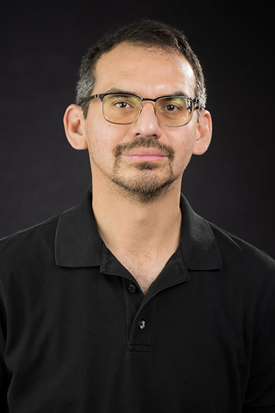 George Diaz, man with short hair, glasses, and gotee in black shirt