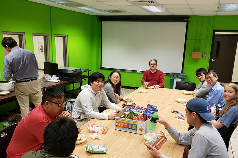 Faculty and students relax after the painting project was completed.