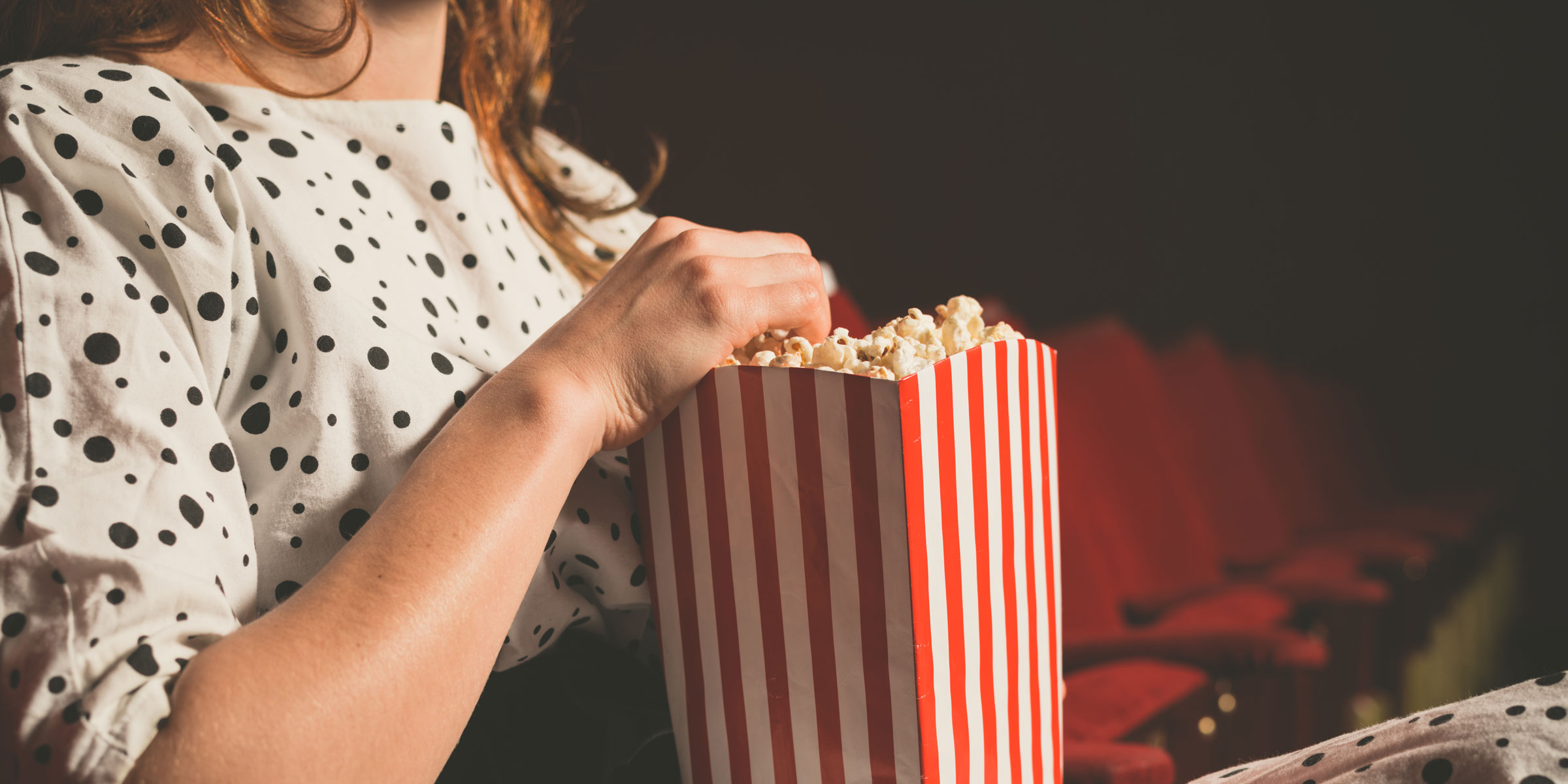 Girl with popcorn at theatre