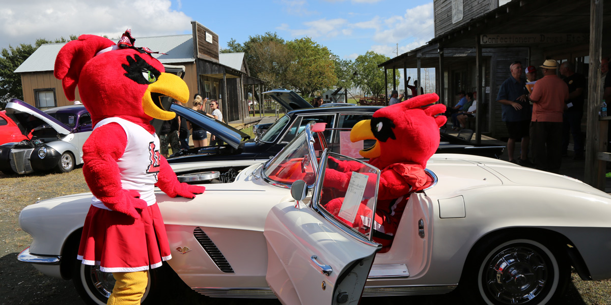 Big Red and Lu in a vintage car
