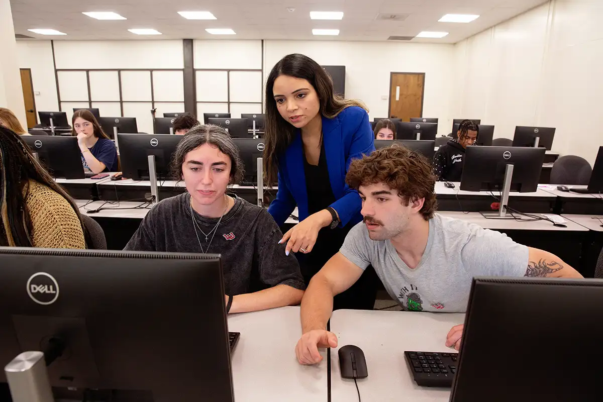 Professor assists students in computer lab
