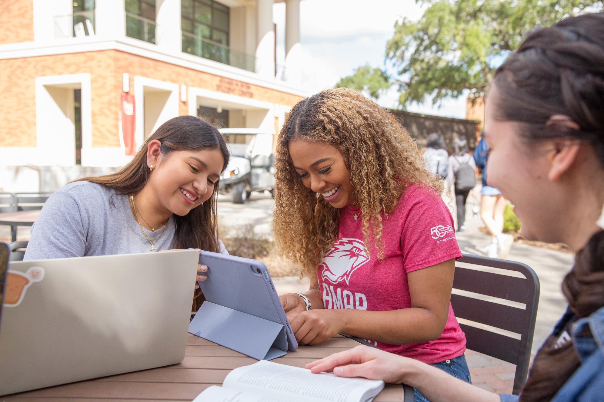 Three students sitting at table 