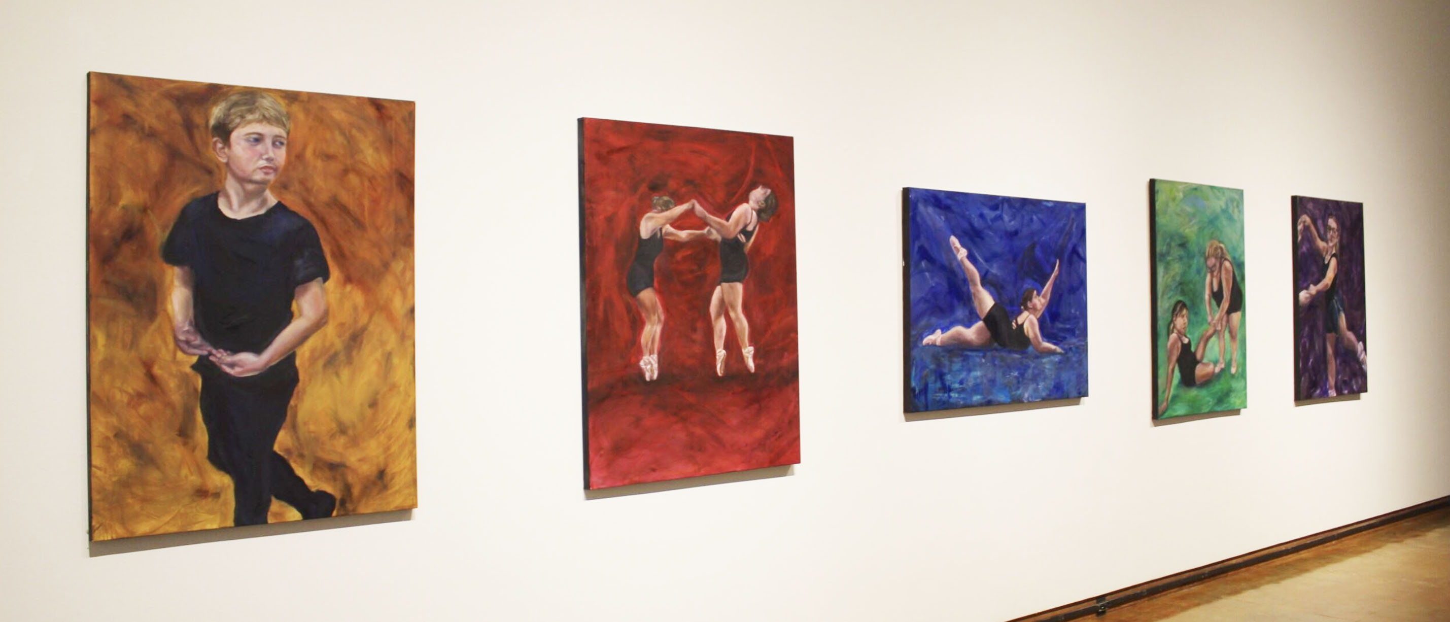 "Gallery wall with five paintings of dancers, each set against different colored backgrounds: orange, red, blue, green, and purple."