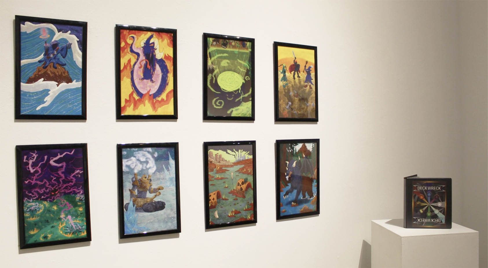 Eight framed colorful illustrations displayed on a wall, with a closed binder labeled "DECKWRECK" on a pedestal.