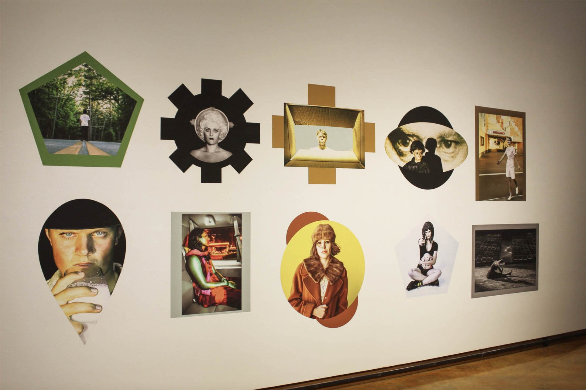 A gallery wall displaying ten artworks with varied geometric frames.