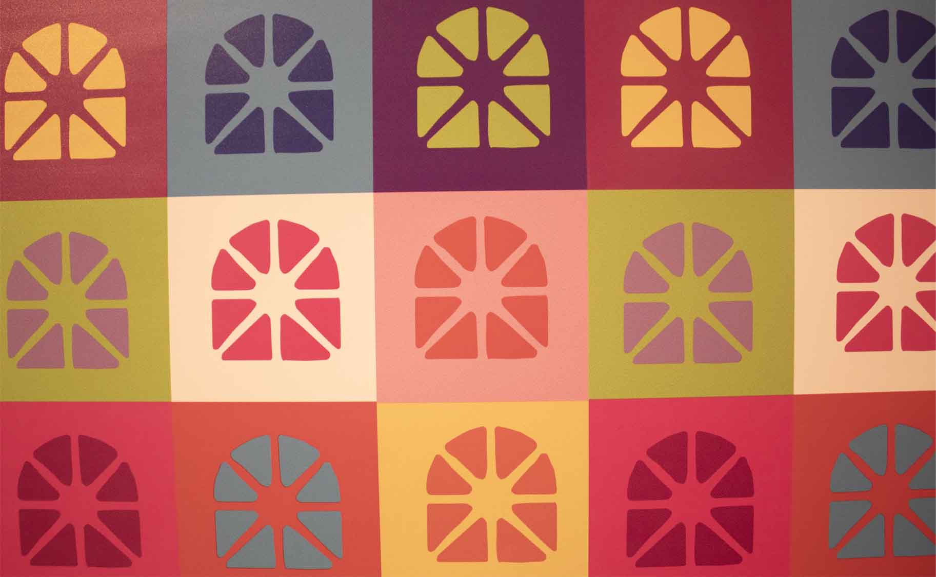 A colorful pattern of squares with arch-like designs, resembling citrus sections, in various contrasting colors.
