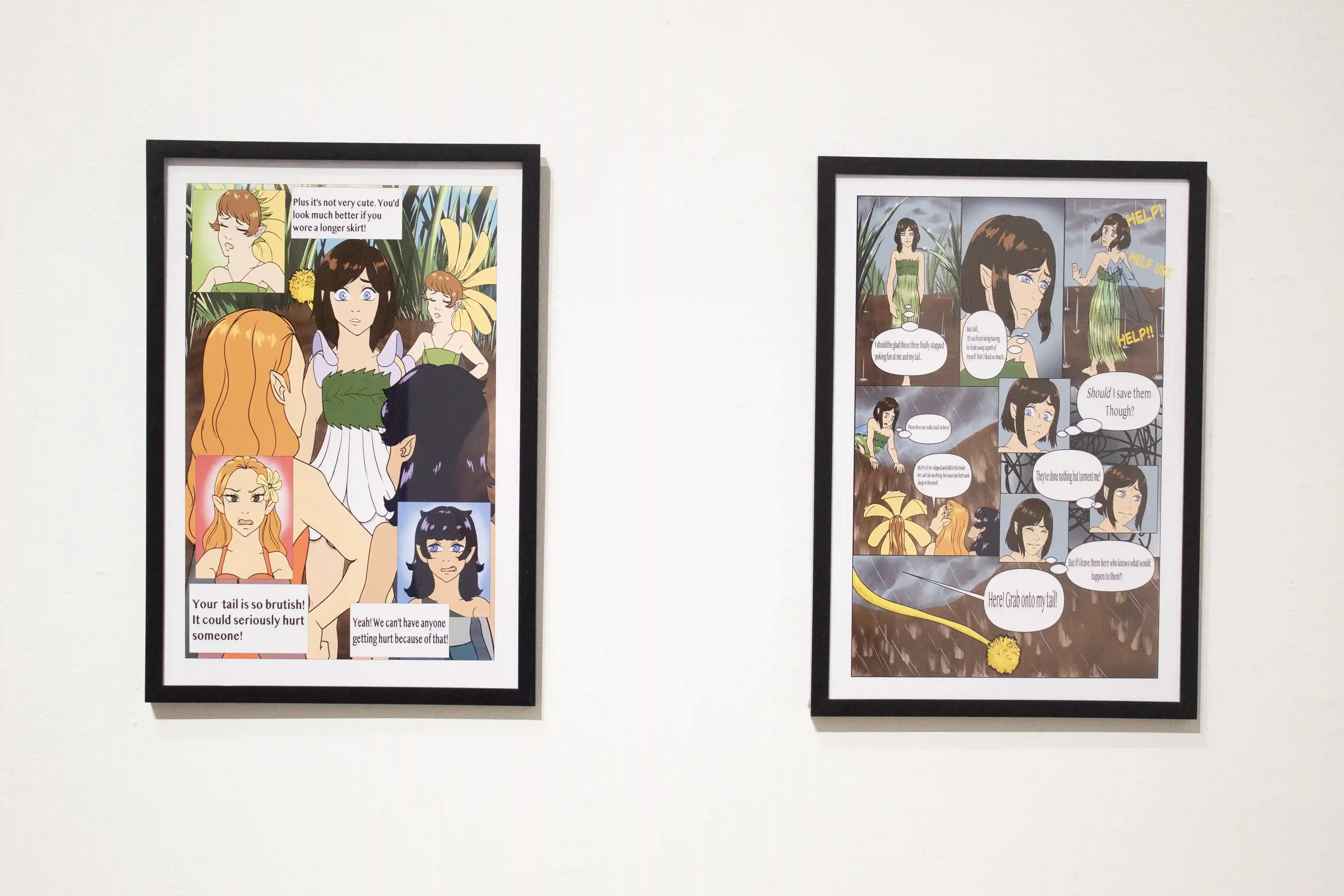 image of 2 framed colorful graphic novel images hanging on wall, both images representative of a graphic novel page with multiple images and text balloons telling the story of A Fairy's Tail