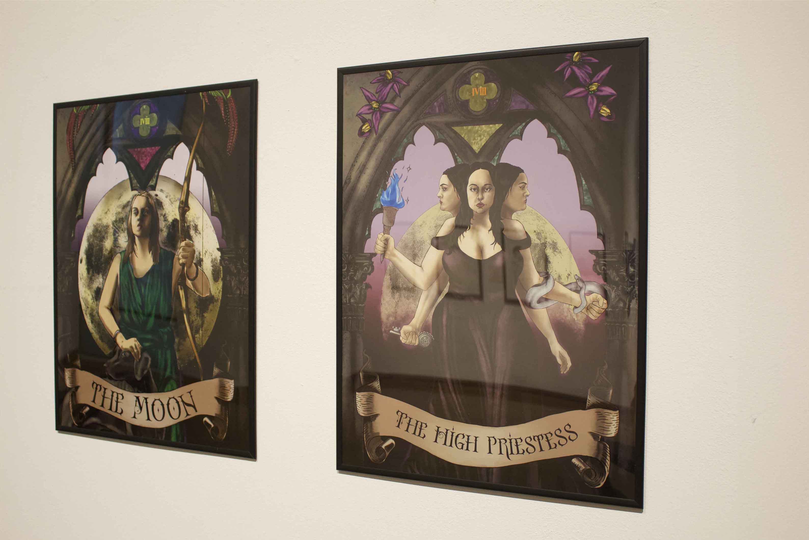 Two framed artworks titled "The Moon" and "The High Priestess" featuring mystical figures within Gothic arches.