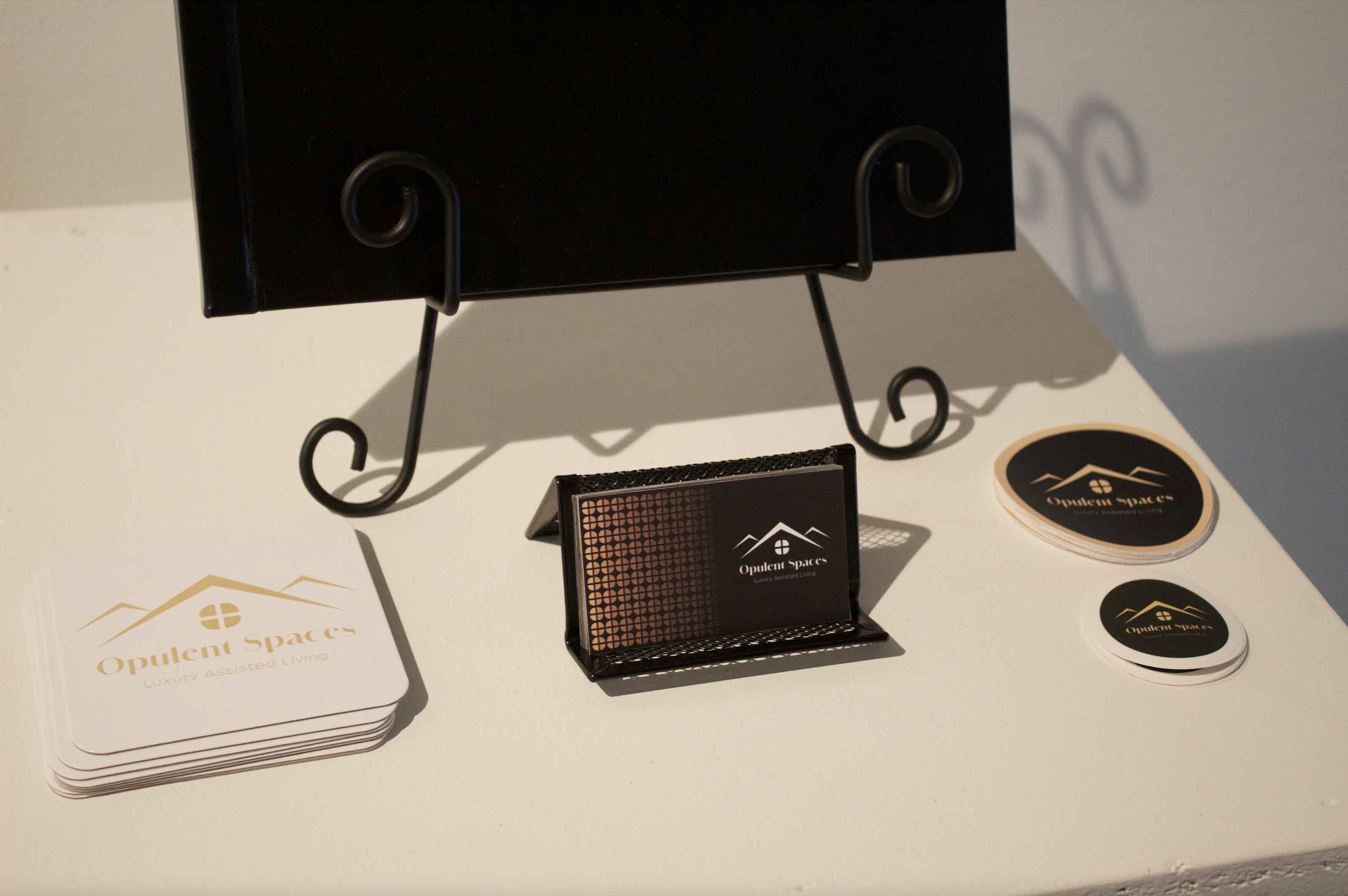 Display with a black easel, coasters, and a business card holder.