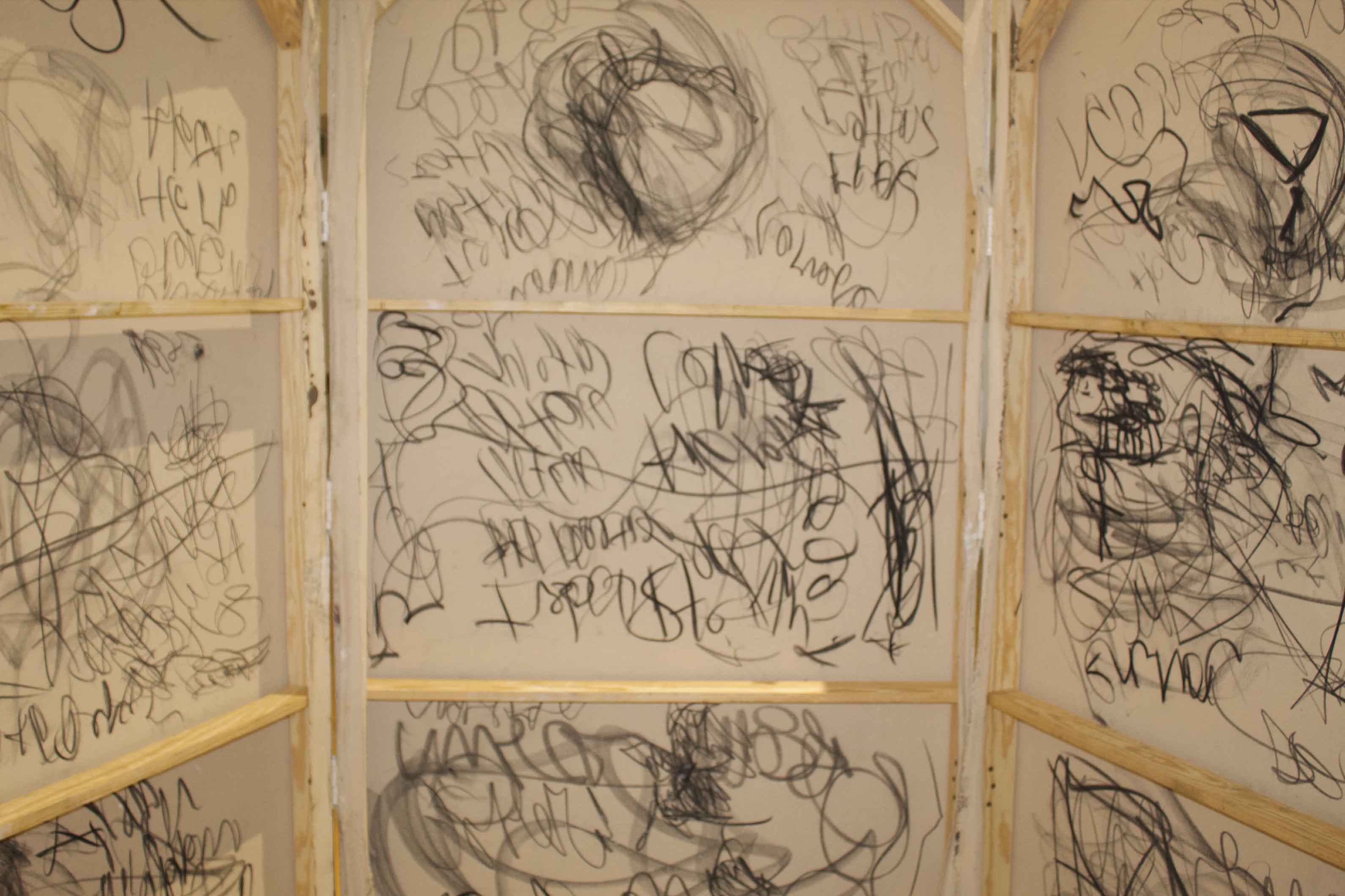 Canvases covered in chaotic black and gray scribbles.