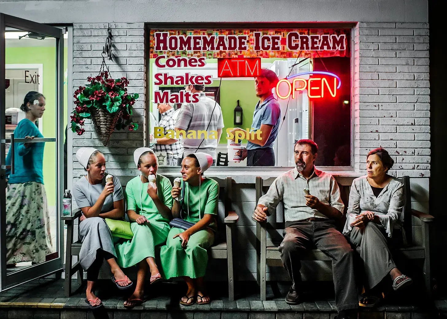 Where the Amish Vacation, amish family eating ice cream cones on bench outside of store