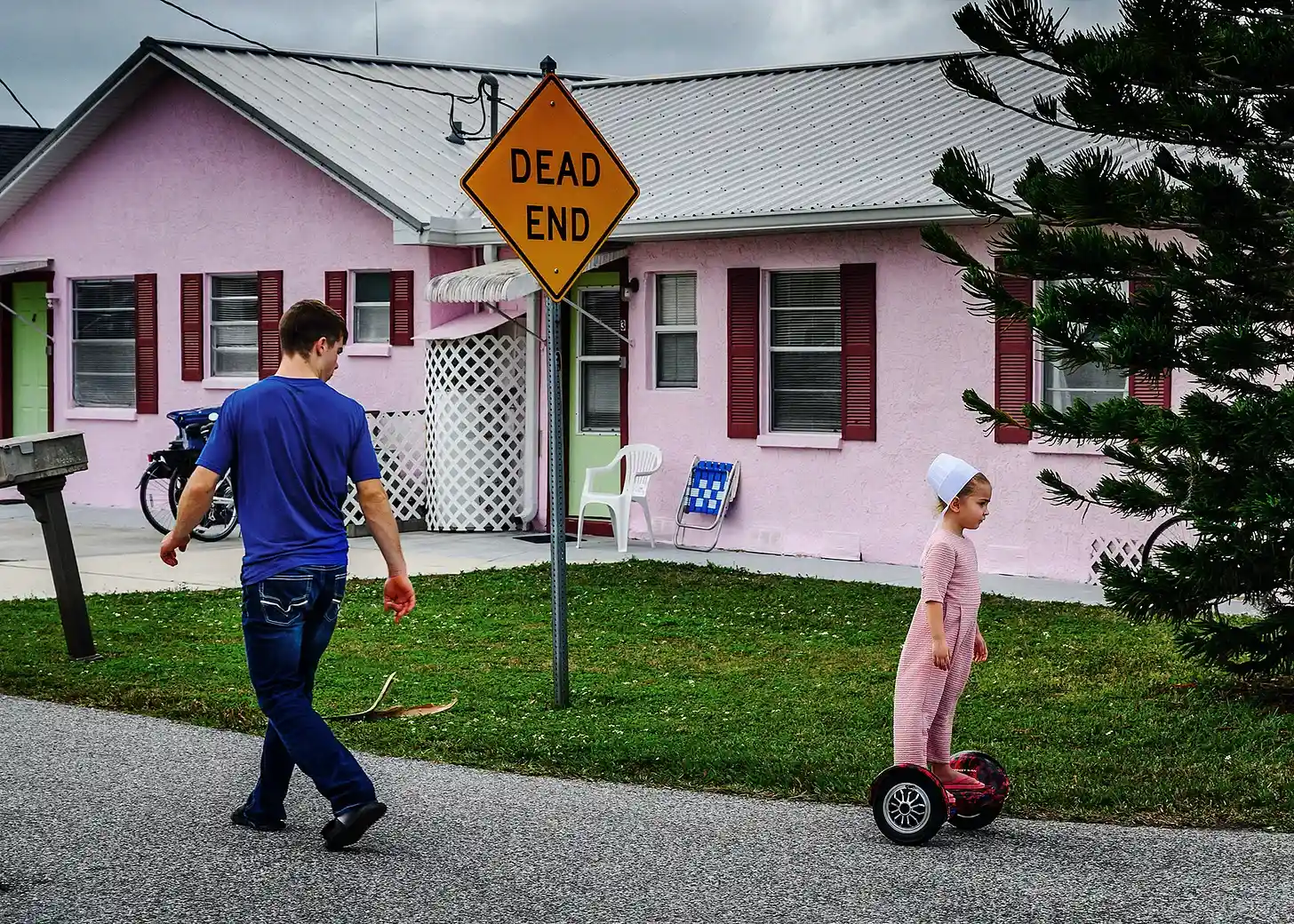 Where the Amish Vacation, teenage boy looking back at young amish girl riding hoverboard