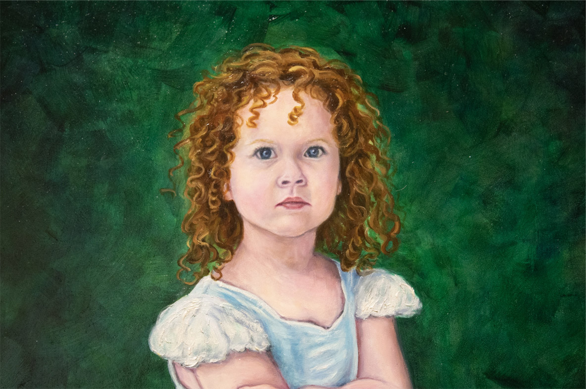 Portrait of a young girl with curly red hair, blue eyes, and crossed arms, wearing a light blue dress with white sleeves, set against a green textured background.