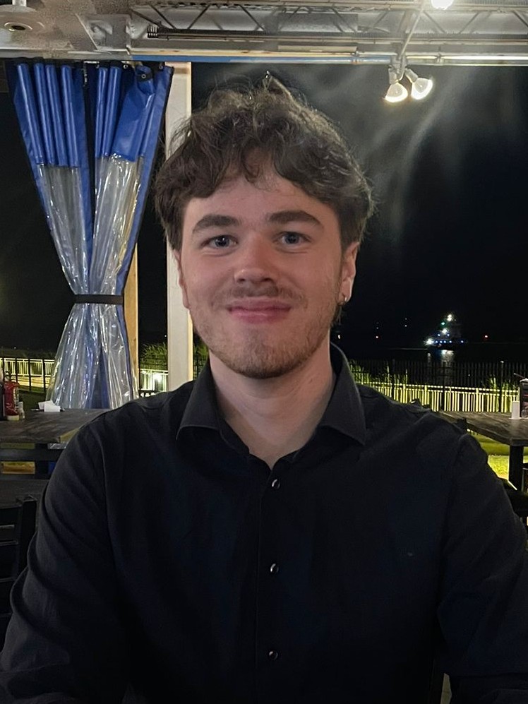 Rick Iterson; image of smiling male, dark hair, black shirt