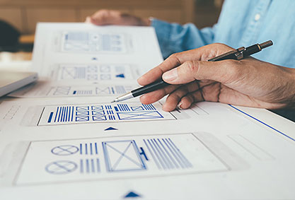 Image shows a hand sketching a course wireframe.