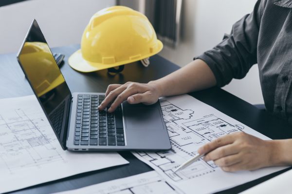 Stock Engineering Photo with Hardhat and Plans