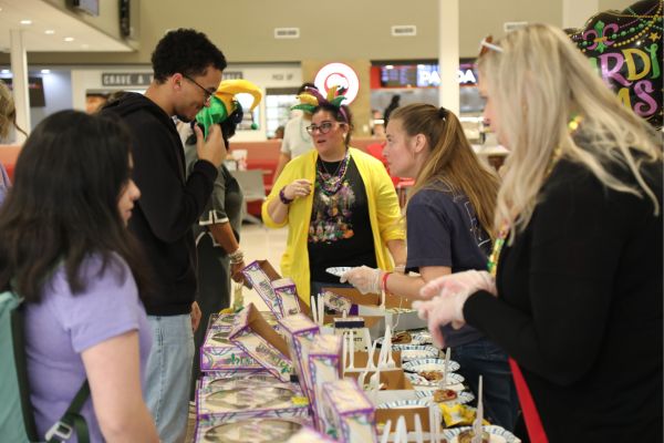 Faculty/Staff serving King Cake