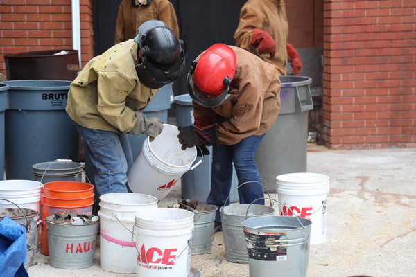 Sculpture students sorting coke at Iron Pour