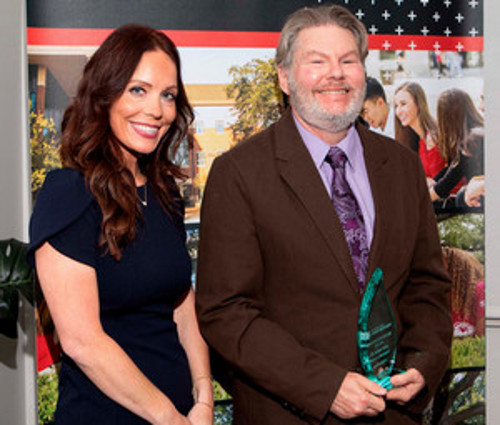 Dr. Vallin receives award  from Dean Thibodeaux 