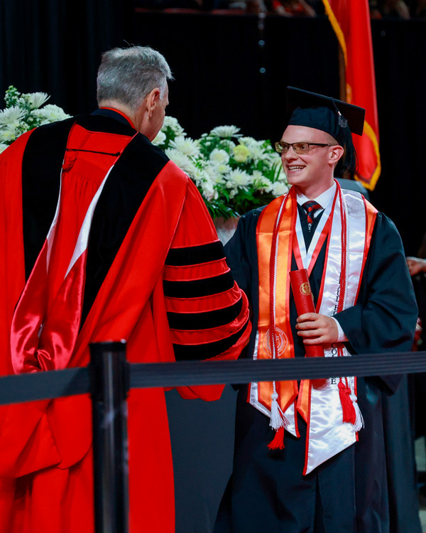 Brandyn New accepts diploma at commencement ceremony 