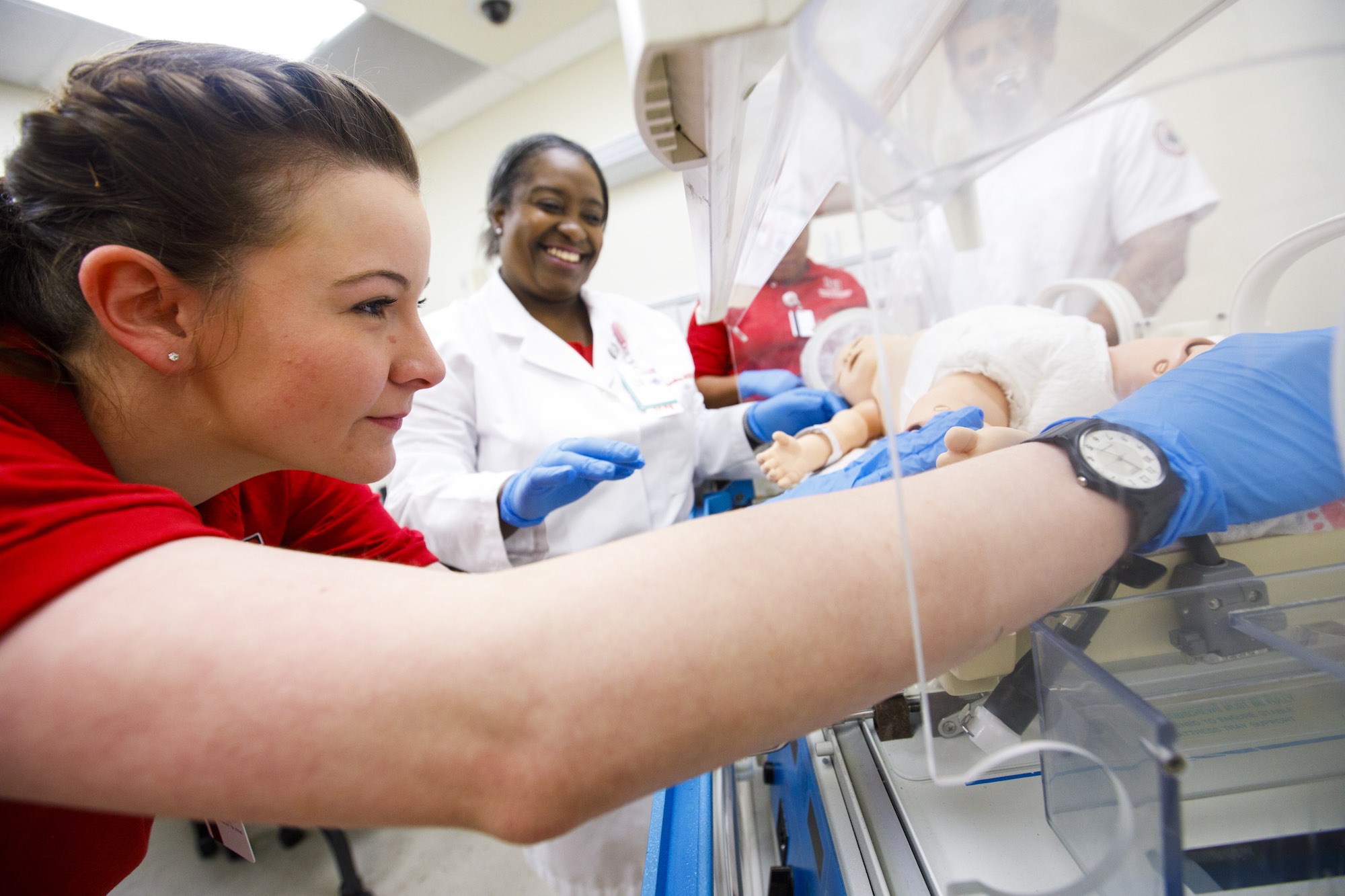 Student working in a simulation with a baby model
