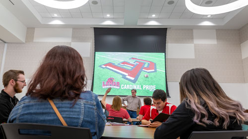 people attending a lecture in the live oak ballroom at the setzer student center