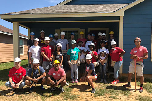 lamar university students in front of habitat for humanity house