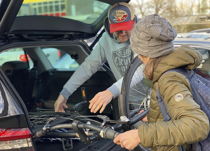 Tammie Nolte’s son Adam, right, and his stepfather, John Leijendekkers, load his bike in Nolte’s car, Monday. The couple picked Adam up after his school was locked down following a shooting in Utrecht, The Netherlands. Courtesy photo by Tammie Nolte
