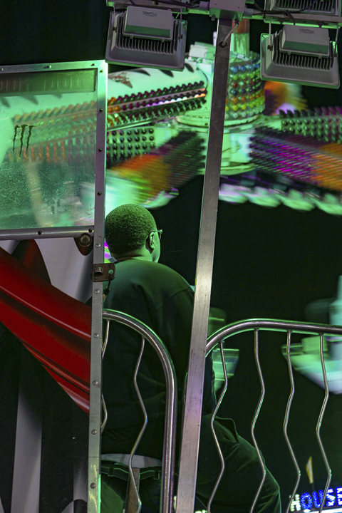 Another carnival worker, left, operates the “Spin Out” ride. UP photo by Lakota Jaton