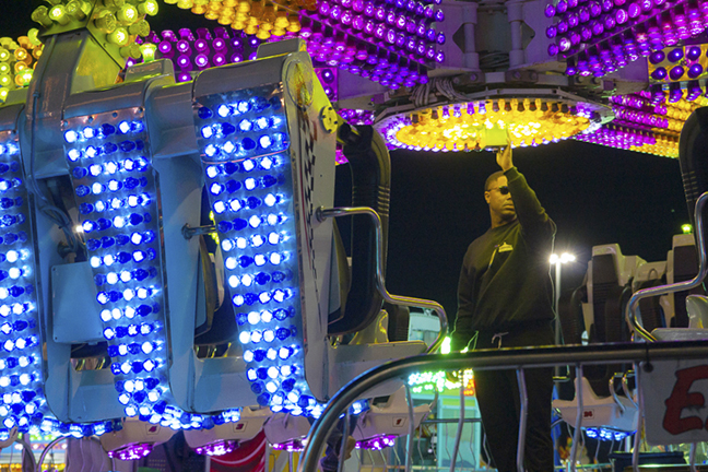 A carnival worker, top, operates the popular ride, “Spin Out,” during the South Texas State Fair at the Ford Park Entertainment Center, March 21. UP photo by Lakota Jaton