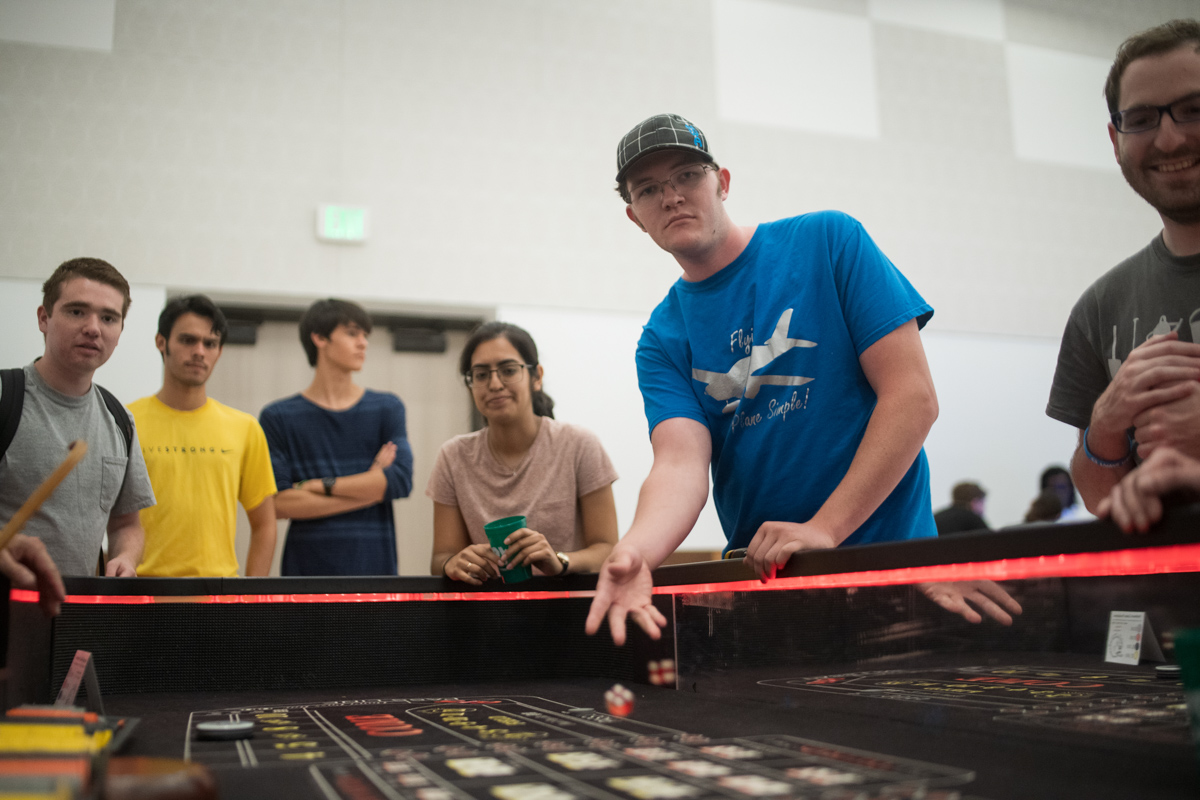 Lamar Student rolls the dice for a game of craps inside the ball room of the Setzer Student Center on Aug 28.