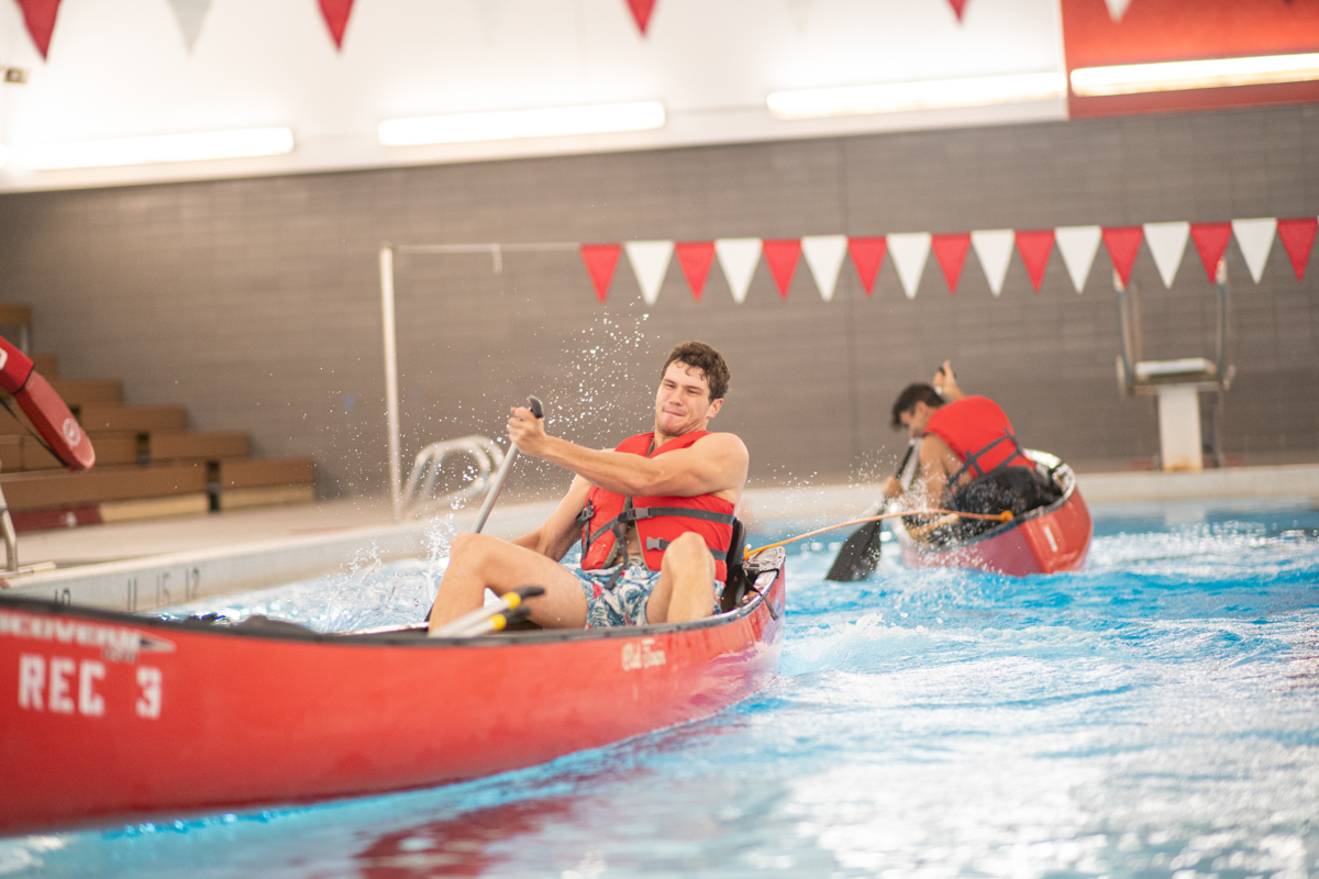 Lamar Students paddle canoes in a water based version of tug of war at the pool inside of the Health and Human Performance Building A on Aug 28. 