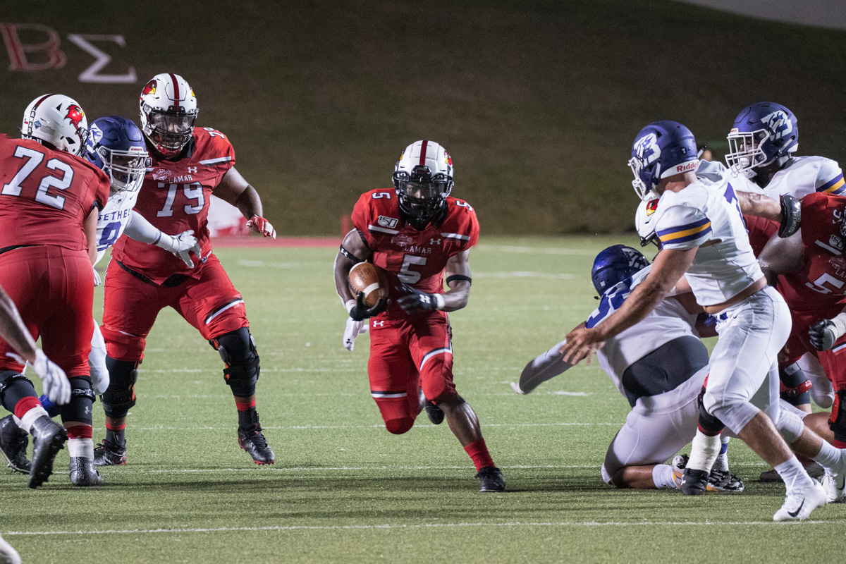 Myles Wanza,  Junior from Houston Texas, runs towards the goal line in the 65 – 16 win against Bethel University at Provost Umphrey stadium on Aug 28. 