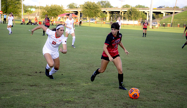 LU forward Madison Ledet kicks the ball past Oklahoma St. defenders at the LU Soccer Complex, Thursday. UP photo by Cade Smith