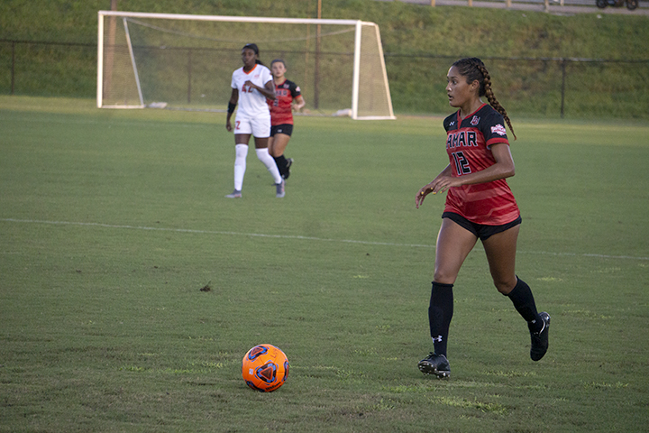 LU midfielder Juana Plata dribbles the ball past Oklahoma St. defenders at the LU Soccer Complex, Thursday. UP photo by Cade Smith