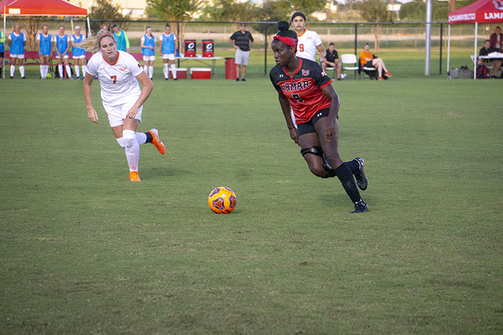 LU forward Esther Okonronkwo dribbles the ball down the pitch against Oklahoma St. defenders at the LU Soccer Complex, Thursday. UP photo by Cade Smith