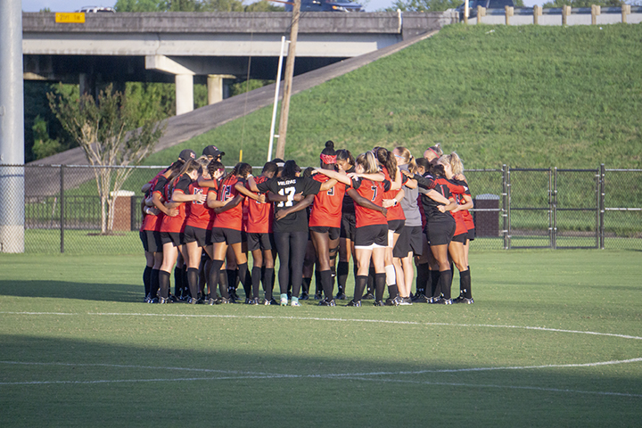 The Lady Cardinal soccer team huddle for their season opener against Oklahoma State at the LU Soccer Complex, Thursday. UP photo by Cade Smith
