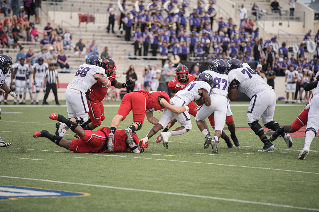 Lamar football players tackle SFA running back during the homecoming game at Provost Umphrey Stadium on Sep 28. UP photo by Noah Dawlearn