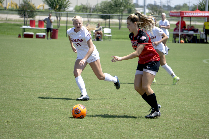 LU forward Lucy Ashworth dribbles the ball past Alabama defenders, Sunday. UP photo by Cade Smith