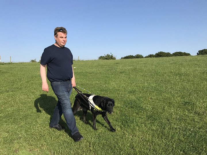 Daniel Walker walks his guide dog, Pebble, across Devil's Dyke on the outskirts of Brighton England. UP photo by Claire Robertson