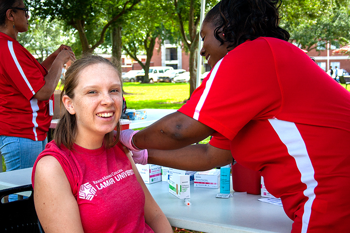 Darya Romashets, Houston freshman, gets her flu shot on the dining hall lawn, Oct. 15. UP photo by Delicia Rocha