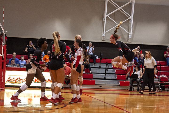 LU’s volleyball players cheer on the court after scoring a point at Saturday’s game against Nichols in the McDonald’s gym. UP Photo by Delicia Rocha