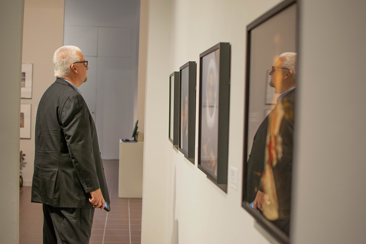 Prince Varughese Thomas, conducts a gallery talk during a reception for his exhibition, “The Legacy of Narcissus,” at the Art Museum of Southeast Texas. The project will be on display until Dec. 1.  UP photo by Lakota Jaton 