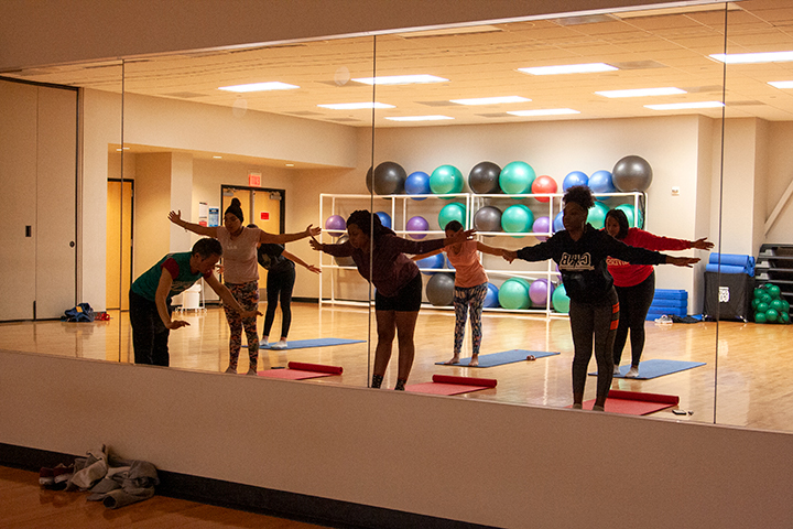 Edwin, the yoga instructor, teaches the class certain poses at Late Night at the Rec on Jan. 24 in the Sheila Umphrey Recreational Center. UP Photo by Delicia Rocha.