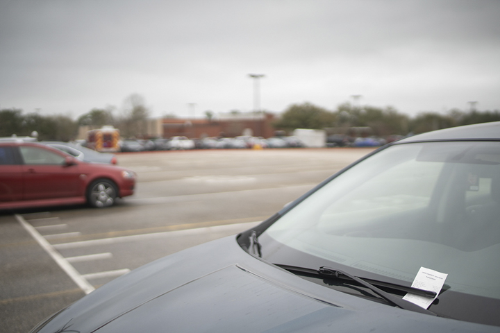 A student’s car is ticketed for parking in the C-4 lot near the Biology Building, Tuesday. The lot is now faculty only, but a students’ first violation will be waived until new signage is installed. UP photo by Noah Dawlearn