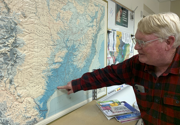 Jim Westgate points to areas that will be effected by rising sea levels in his office at the department of earth and space sciences, Feb. 26. UP photo by Christina Segura
