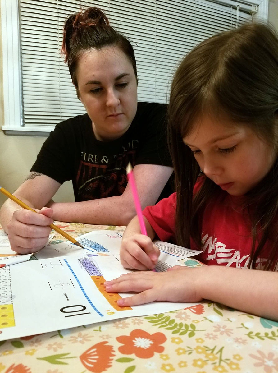 LU student Rachel Hellums works works with her daughter on school work at home. Courtesy photo